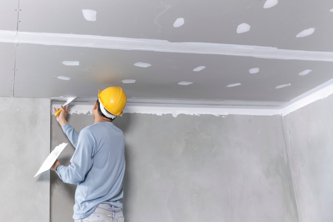 Craftsman working with plaster gypsum ceiling for interior build